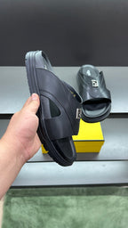 Fendi slide sandals in dark leather, side view with thick platform sole