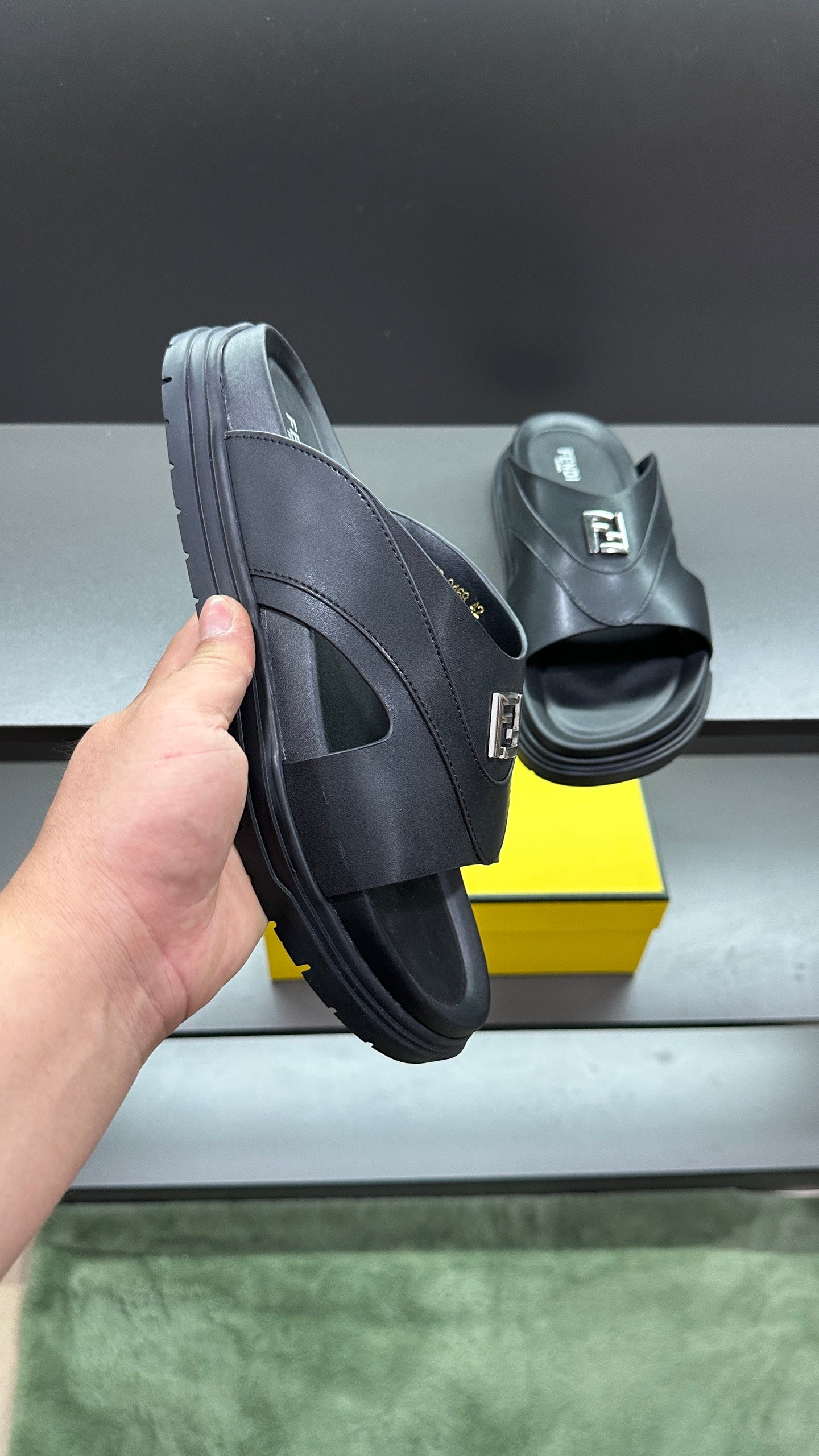 Fendi slide sandals in dark leather, side view with thick platform sole