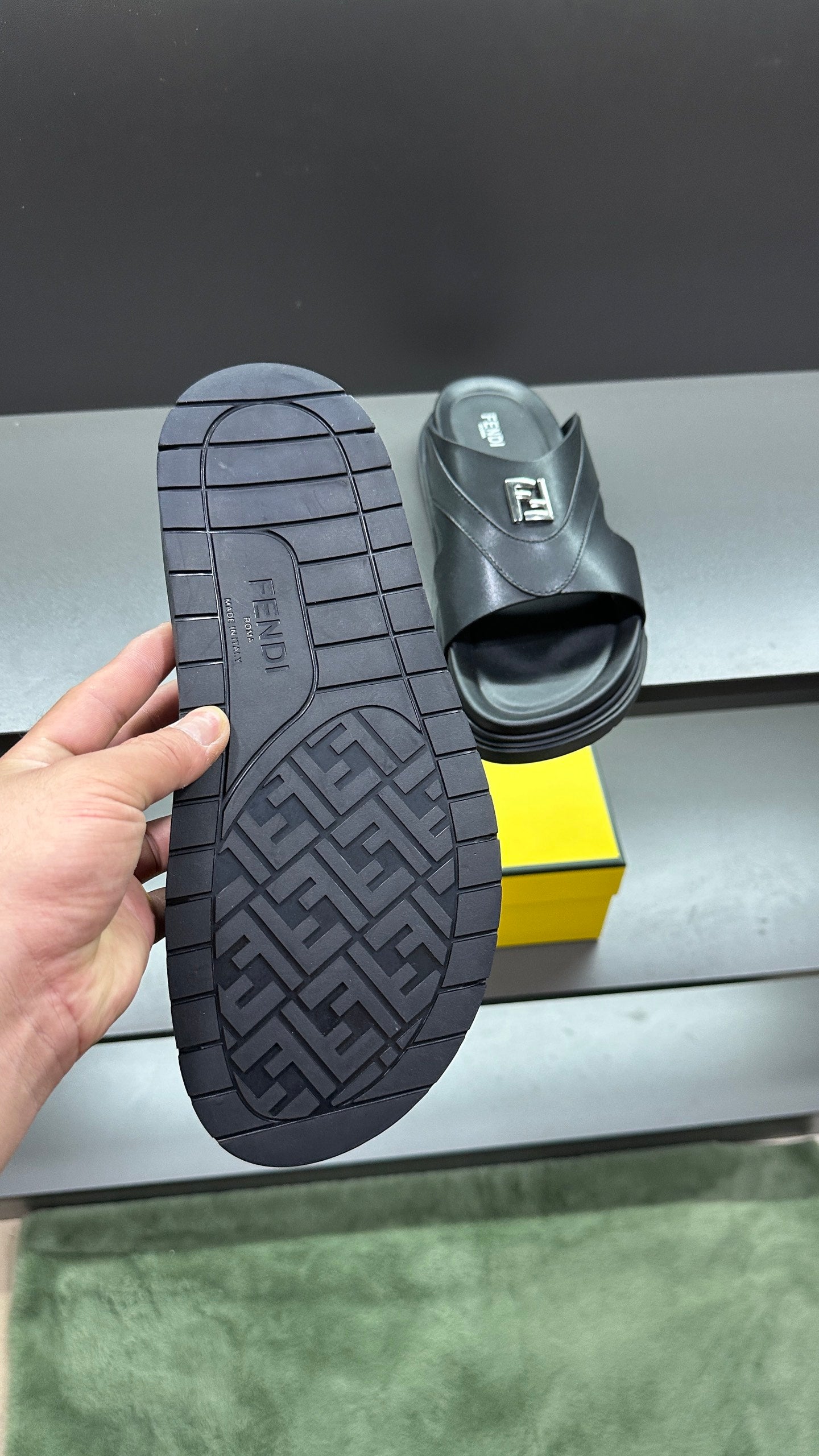 Fendi dark sandal outsoles with patterned tread, sole-first view