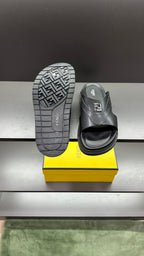 Fendi dark slide sandals with patterned outsole, heel tread visible on pair