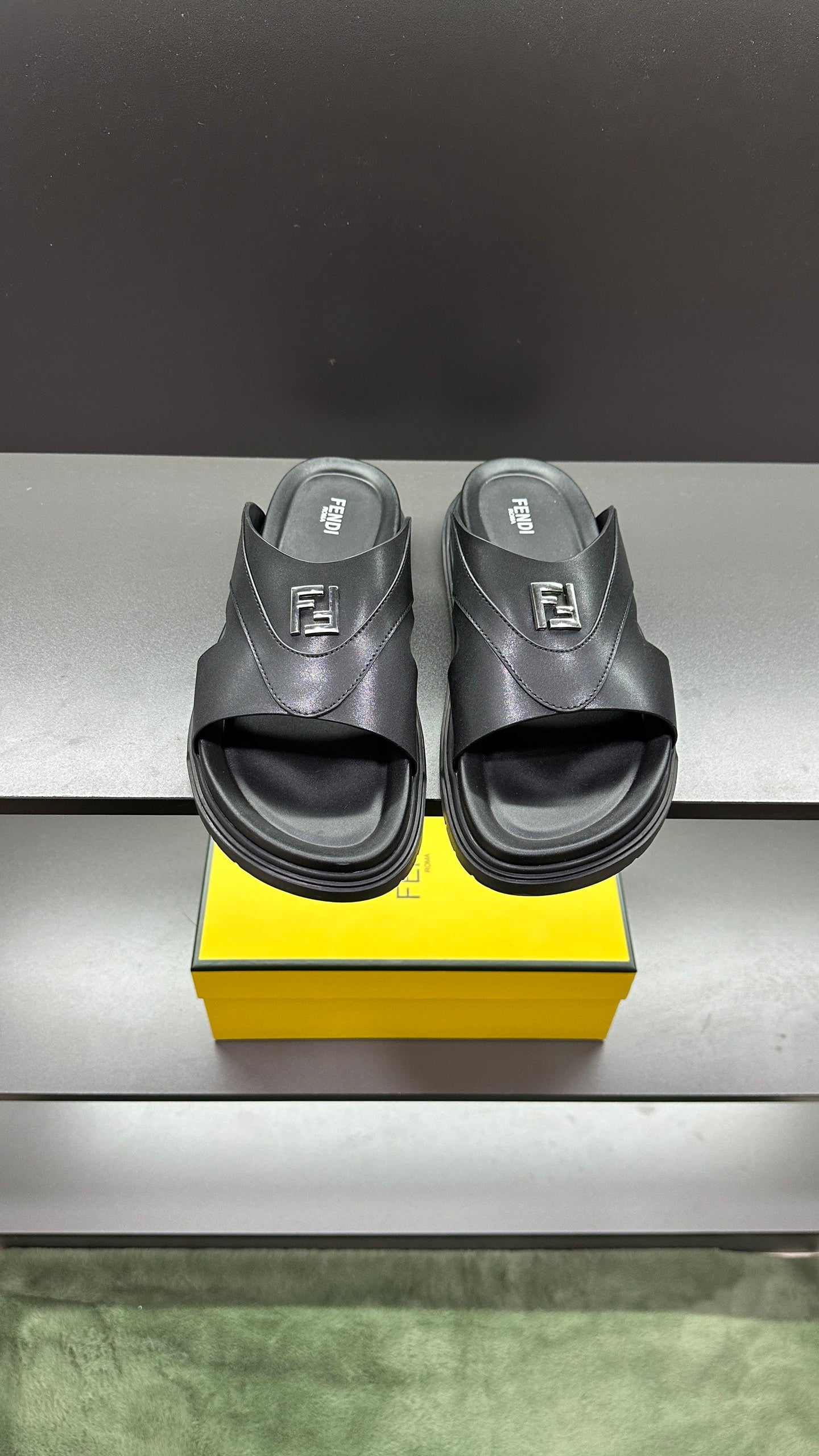Fendi slide sandals with black leather straps and open toe, chunky rubber sole