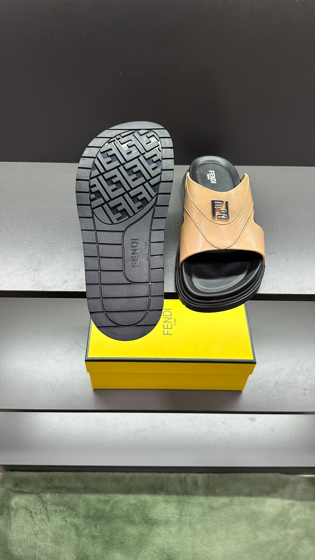 Fendi beige slide sandals with full outsole view; dark tread pattern and F logo