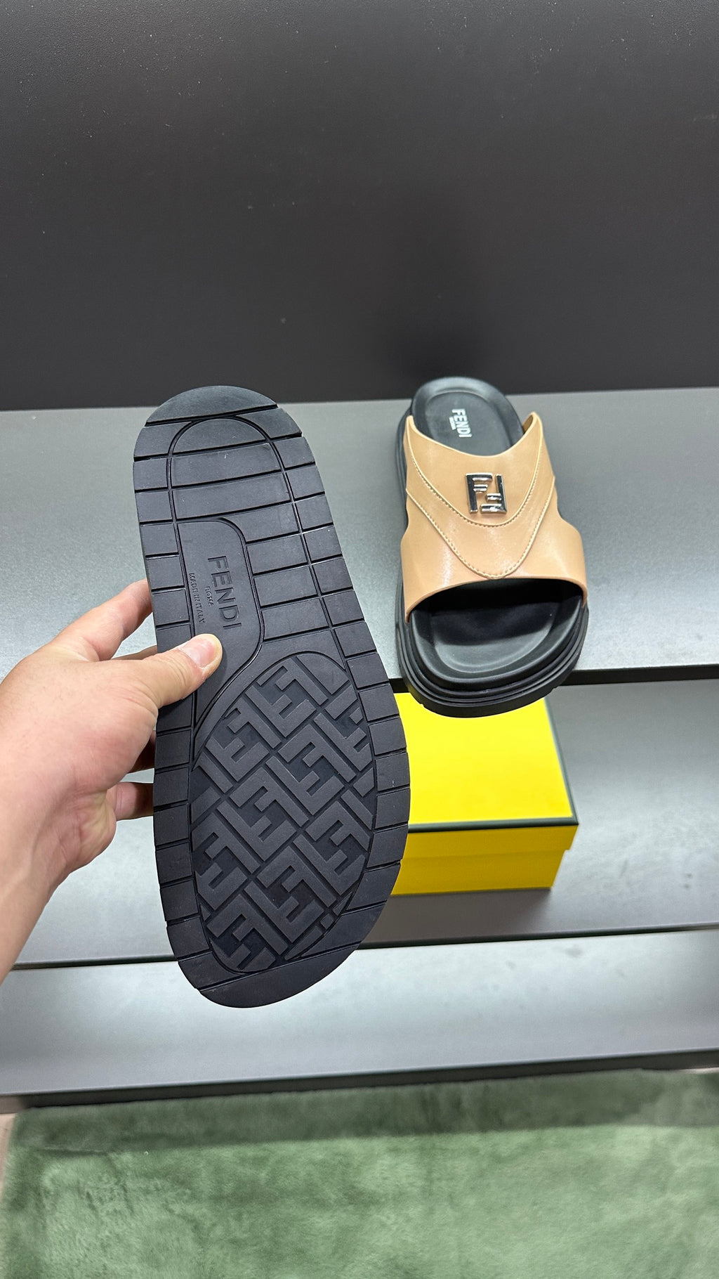Fendi beige slide sandals outsole shown; textured tread and F logo on footbed