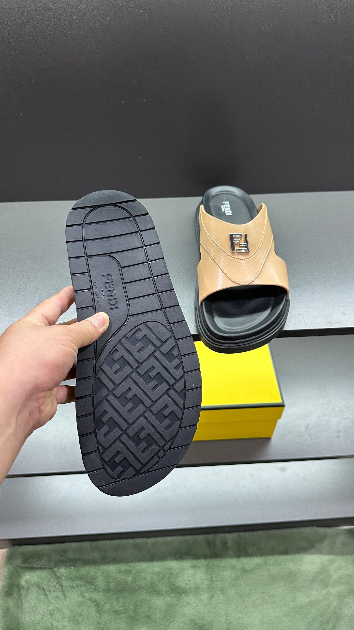 Fendi beige slide sandals outsole shown; textured tread and F logo on footbed