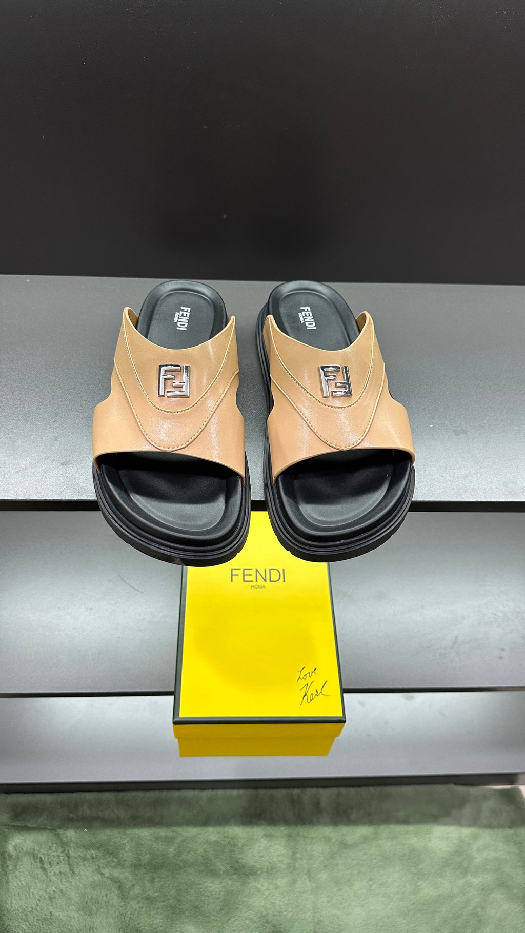 Fendi beige slide sandals with black sole and F logo detail, cushioned footbed