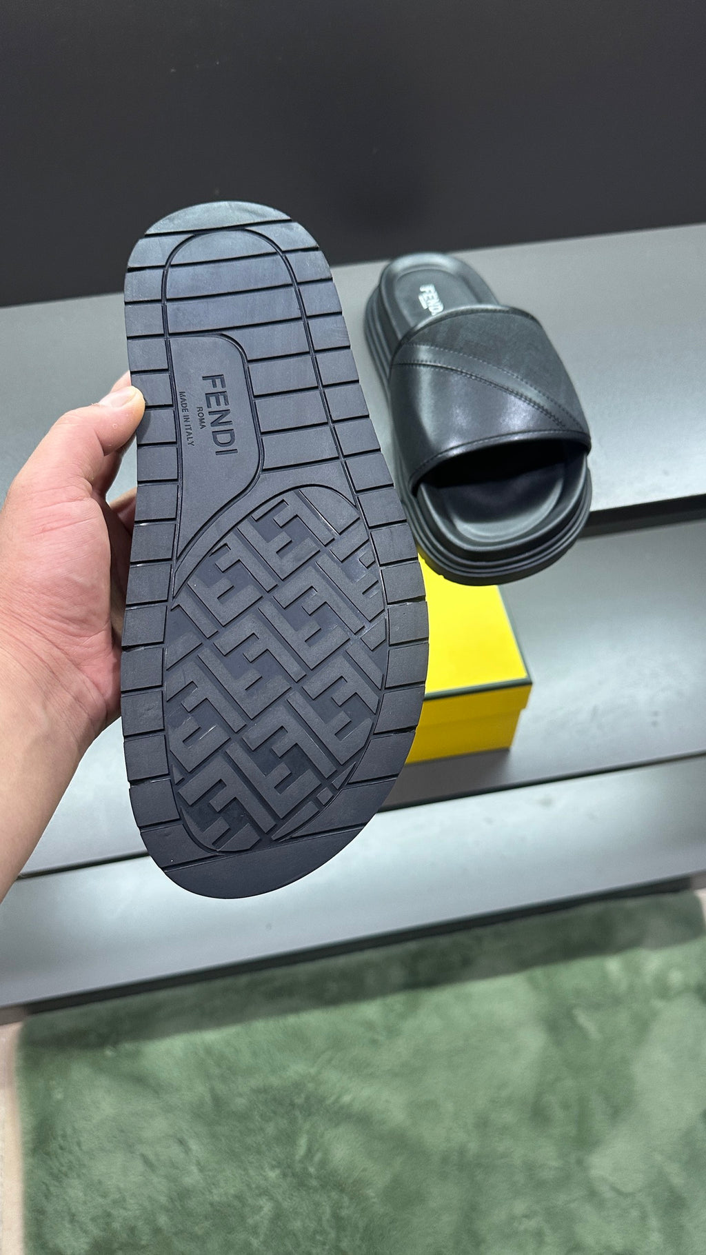 Fendi slide sandals with outsole tread visible, dark upper and platform footbed