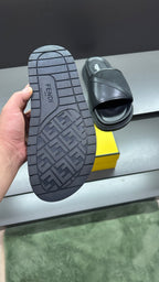 Fendi slide sandals with outsole tread visible, dark upper and platform footbed