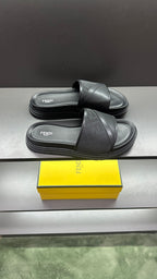 Fendi slide sandals with wide dark strap and thick ribbed platform sole