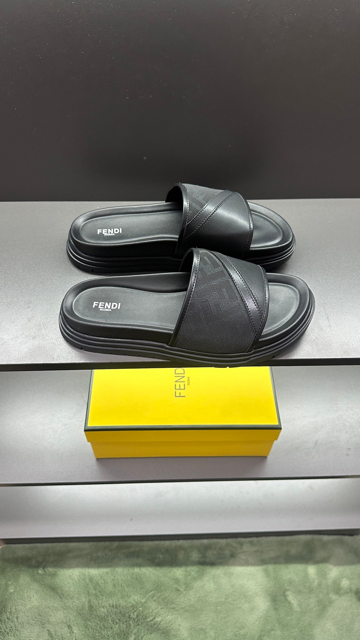 Fendi slide sandals with wide dark strap and thick ribbed platform sole