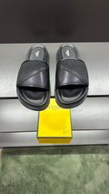 Fendi slide sandals in dark color with wide cross strap and cushioned platform sole