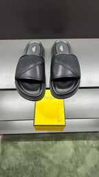Fendi slide sandals in dark color with wide cross strap and cushioned platform sole