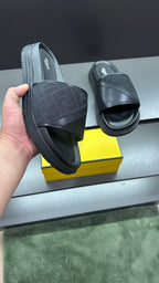 Fendi slide sandals with dark textured upper and wide strap over platform sole