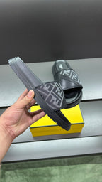 Dark slide sandals with FF logo strap, front sole shown in hand