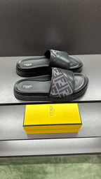 Dark slide sandals with FF logo straps and padded platform sole