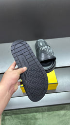 Outsole view of dark slide sandals with FF logo tread pattern