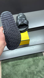 Fendi black slide sandals showing treaded outsole and heel logo