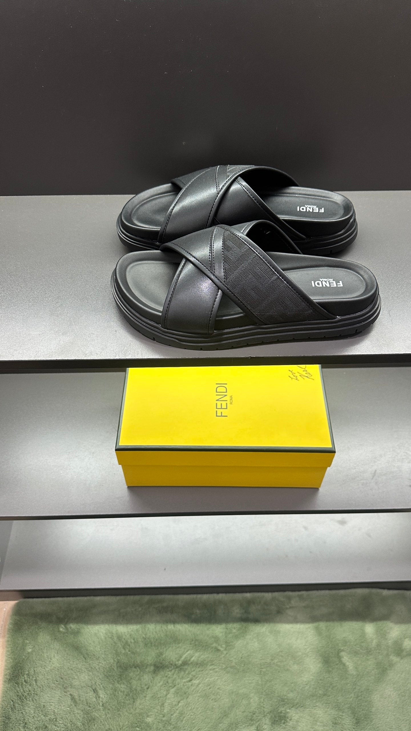 Fendi black slide sandals, side view with cushioned footbed