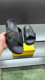 Fendi black slide sandals held by hand, wide strap with FF logo