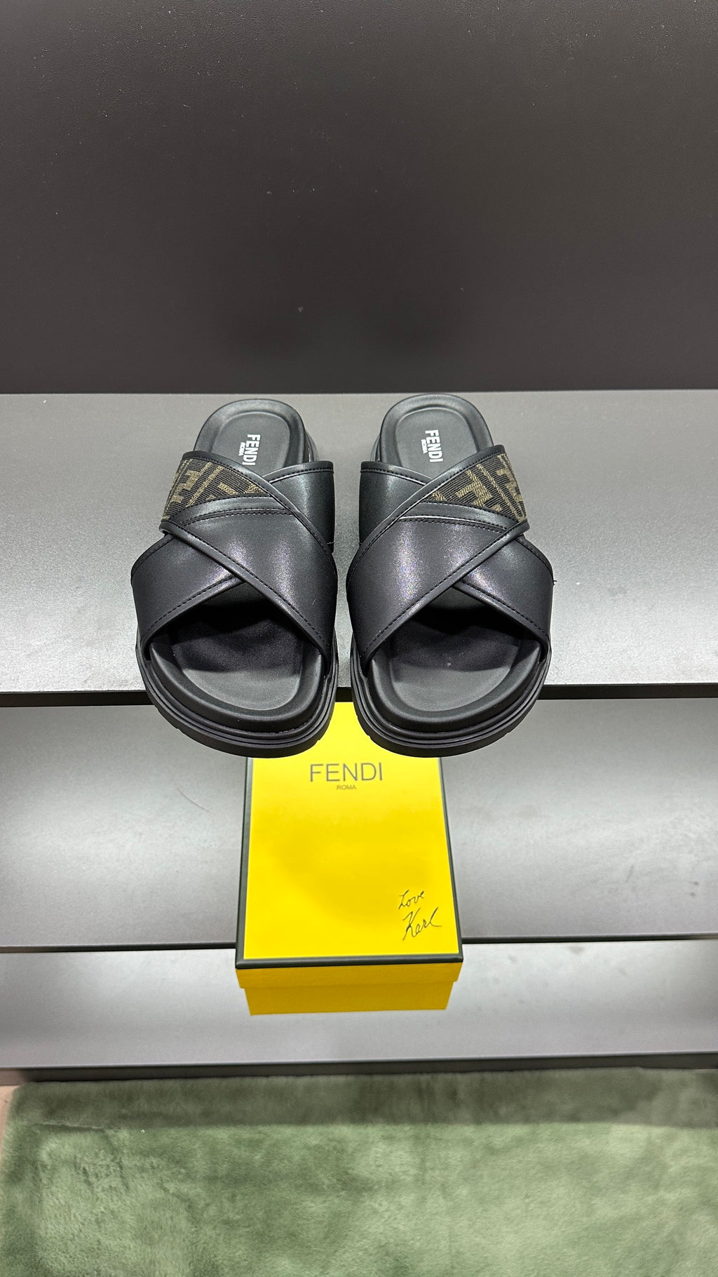 Fendi black slide sandals with wide crisscross straps and FF logo