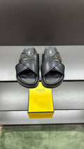 Fendi black slide sandals with wide crisscross straps and FF logo