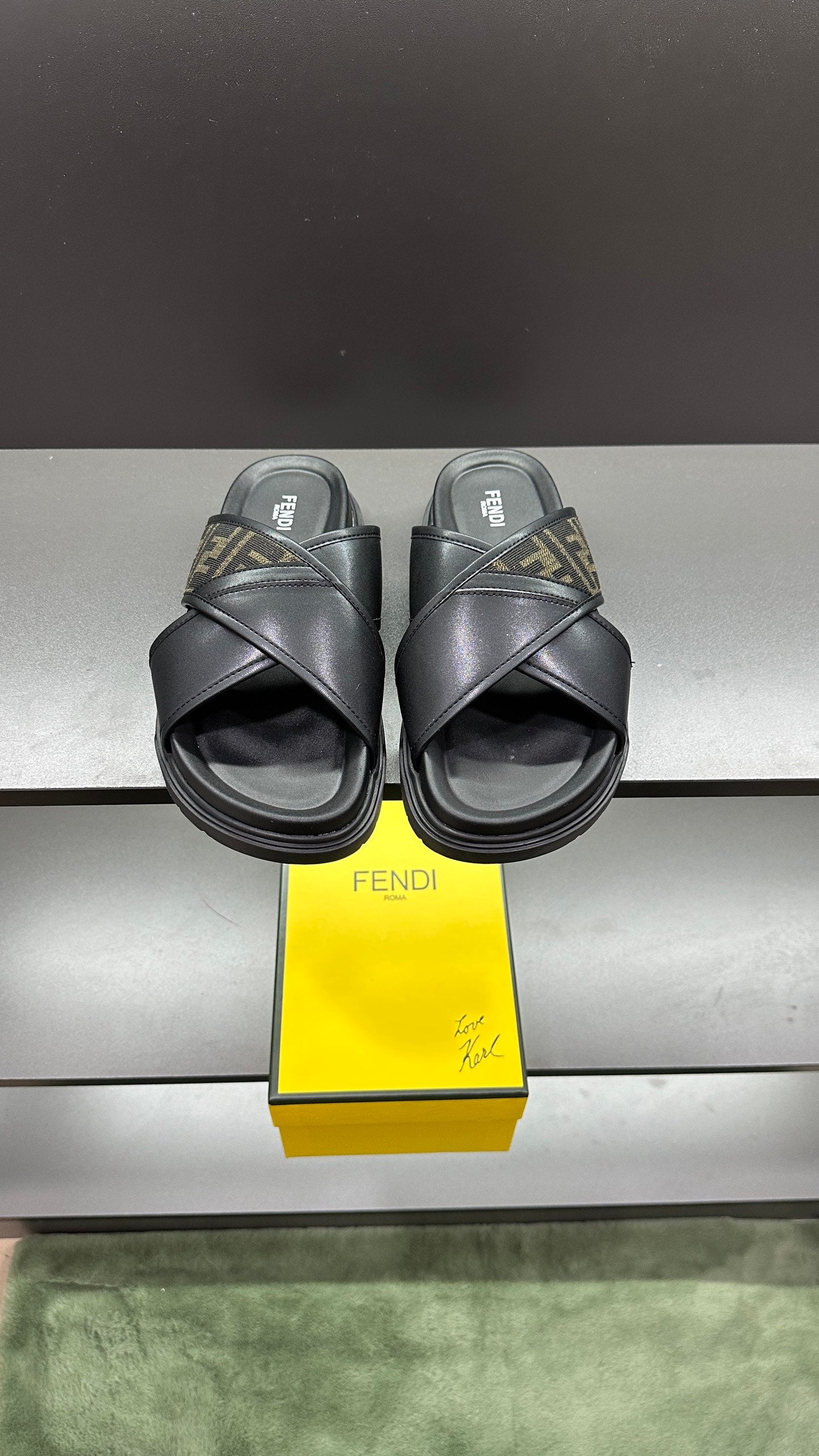 Fendi black slide sandals with wide crisscross straps and FF logo