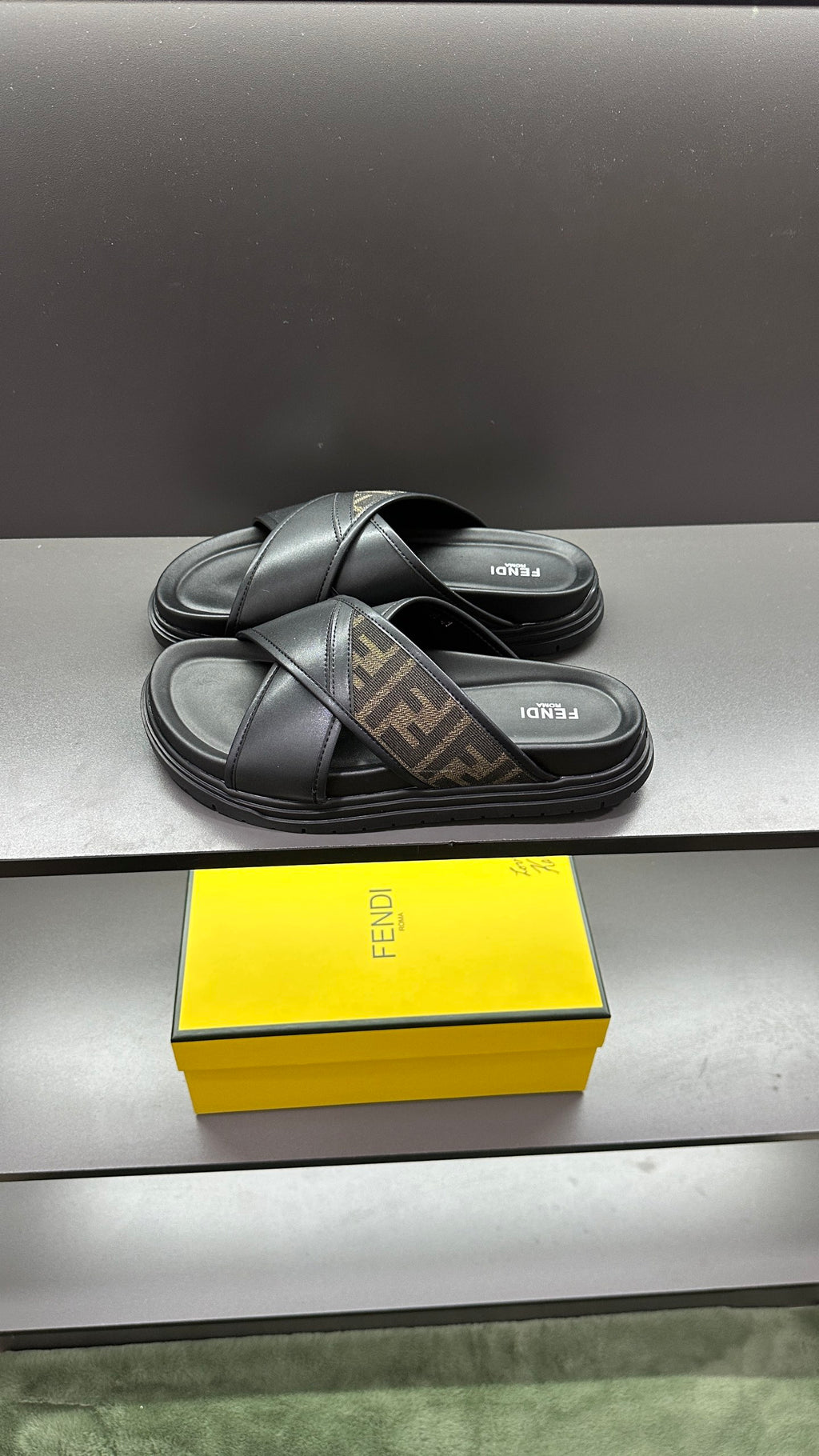 Fendi black slide sandals with crisscross strap and FF logo insole