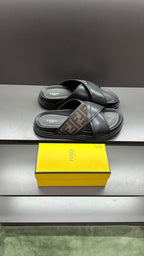 Fendi black slide sandals, side view, with FF logo on front strap