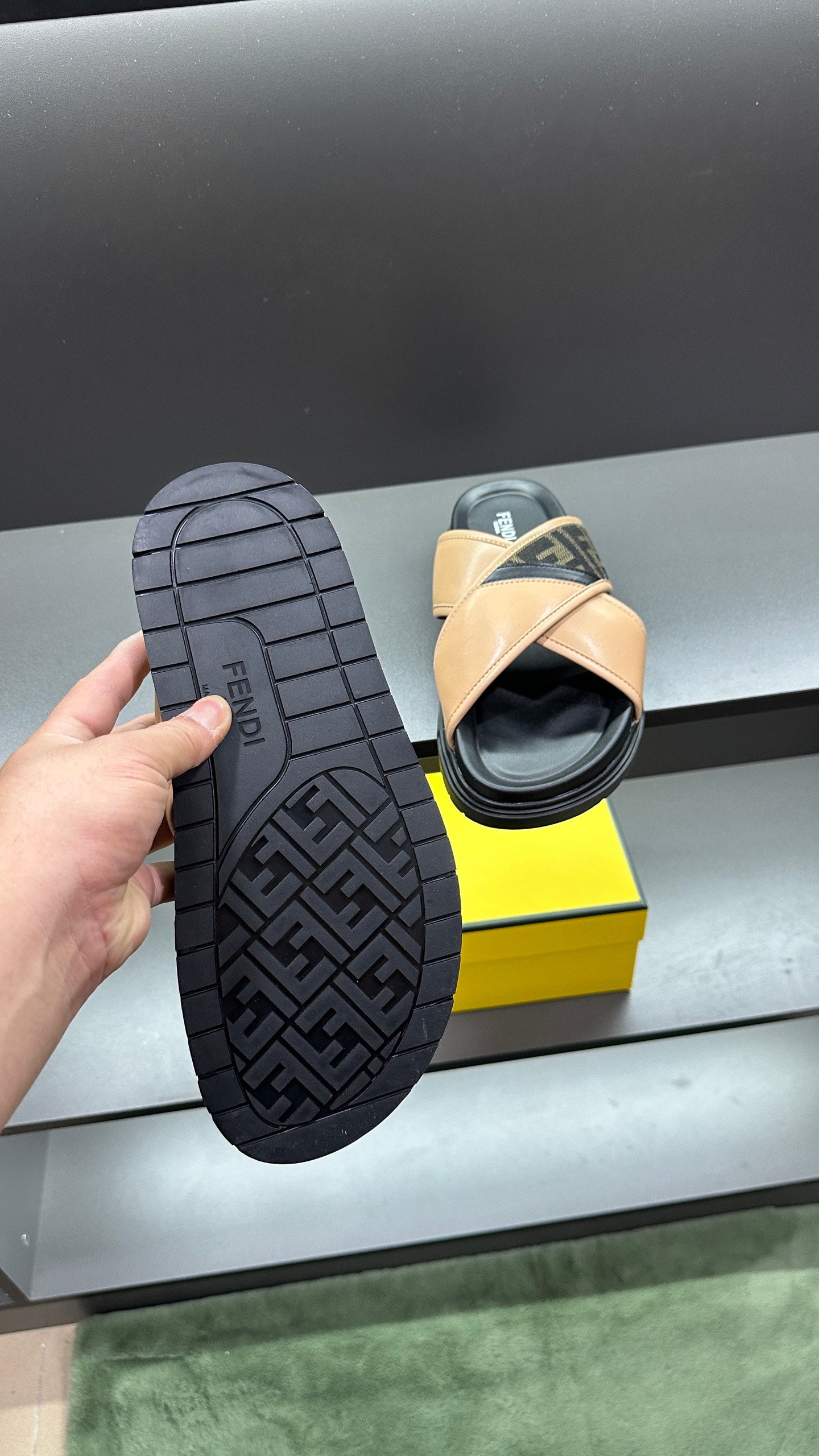 Fendi slide sandals, black treaded outsole with Fendi logo pattern, beige upper