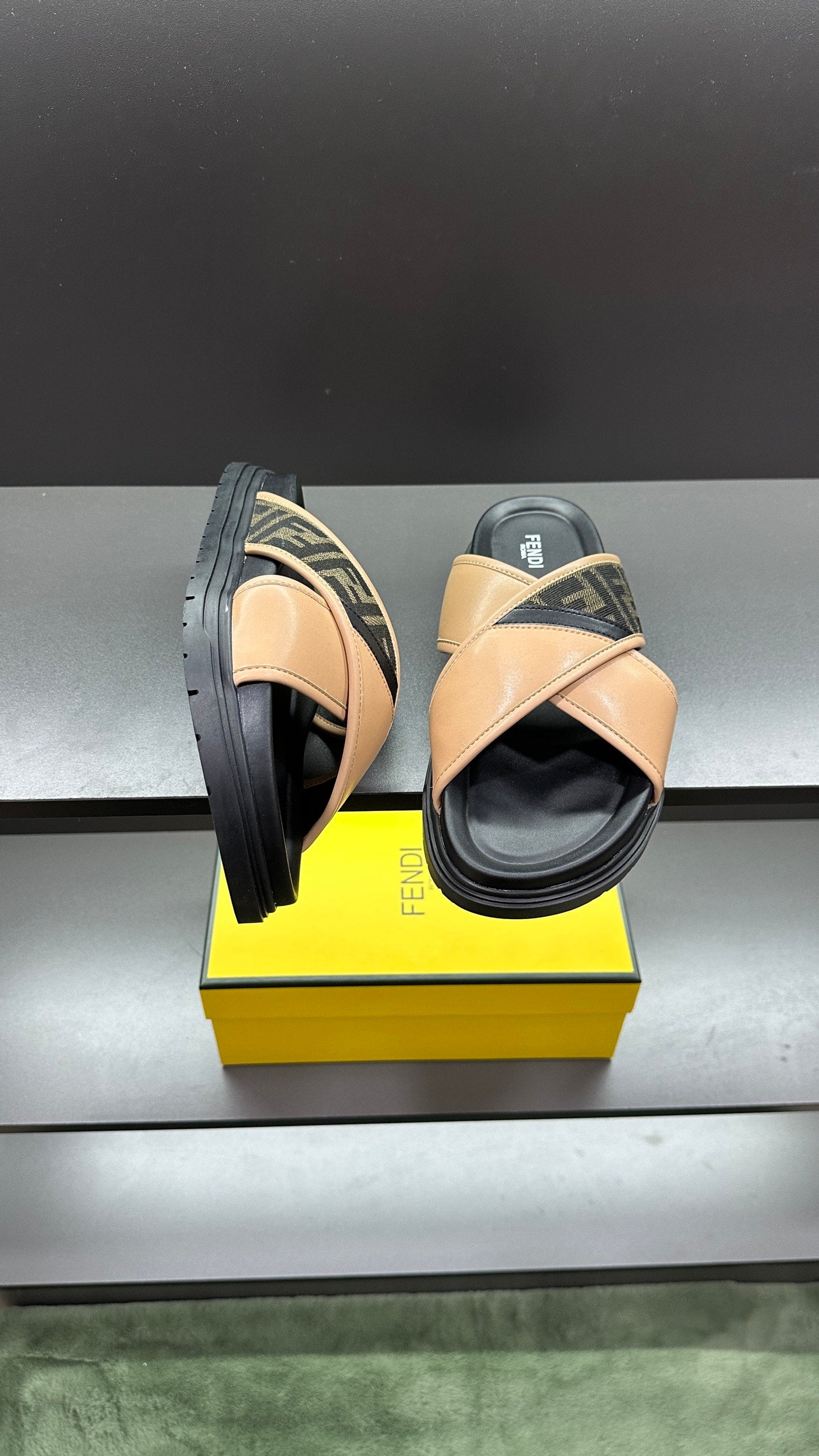 Fendi slide sandals with beige upper, dark logo side panel, black sole