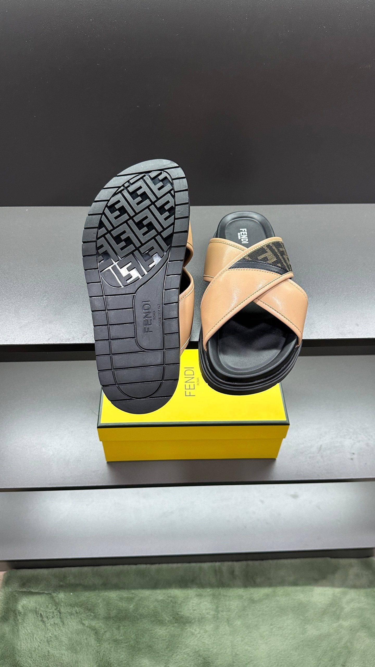 Fendi slide sandals with textured black outsole featuring Fendi logo pattern, beige upper