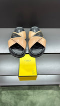 Fendi slide sandals with beige crisscross straps, dark logo trim, black sole