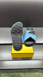 Fendi blue sandals with patterned tread outsole, back view on yellow box