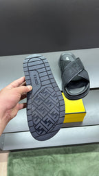 Fendi slide sandal with dark tread outsole showing FF pattern, open top