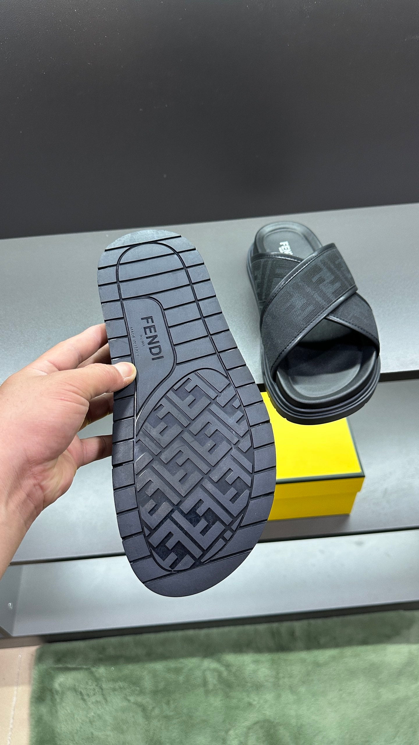 Fendi slide sandal with dark tread outsole showing FF pattern, open top