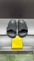 Fendi slide sandals with dark textured strap and logo lettering, open toe and thick sole