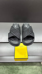 Fendi slide sandals with dark textured strap and logo lettering, open toe and thick sole