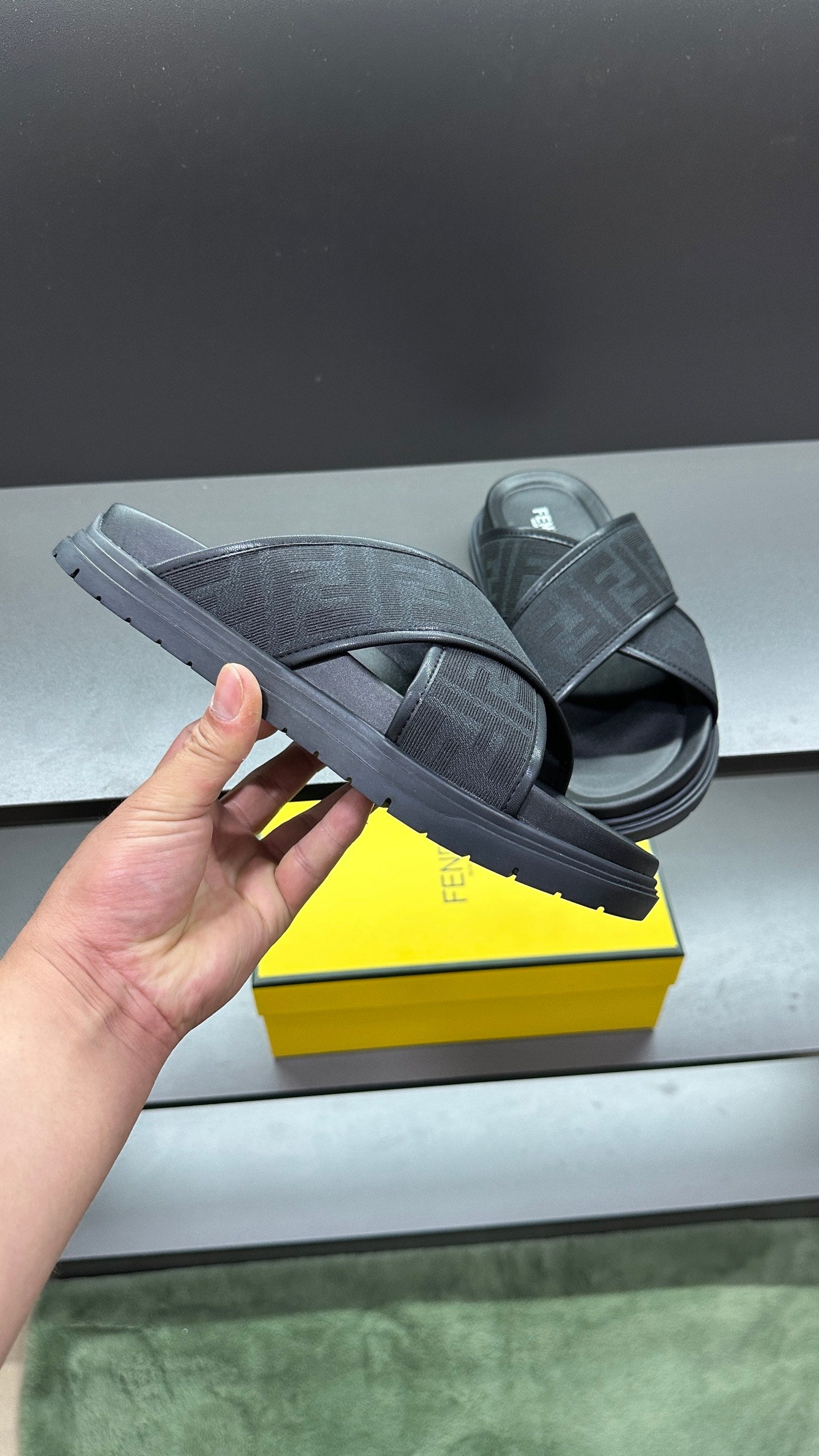 Dark Fendi slide sandals with FF logo straps, thick rubber sole and padded footbed