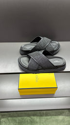 Fendi slide sandals on dark footbeds with crossed FF logo straps and textured soles