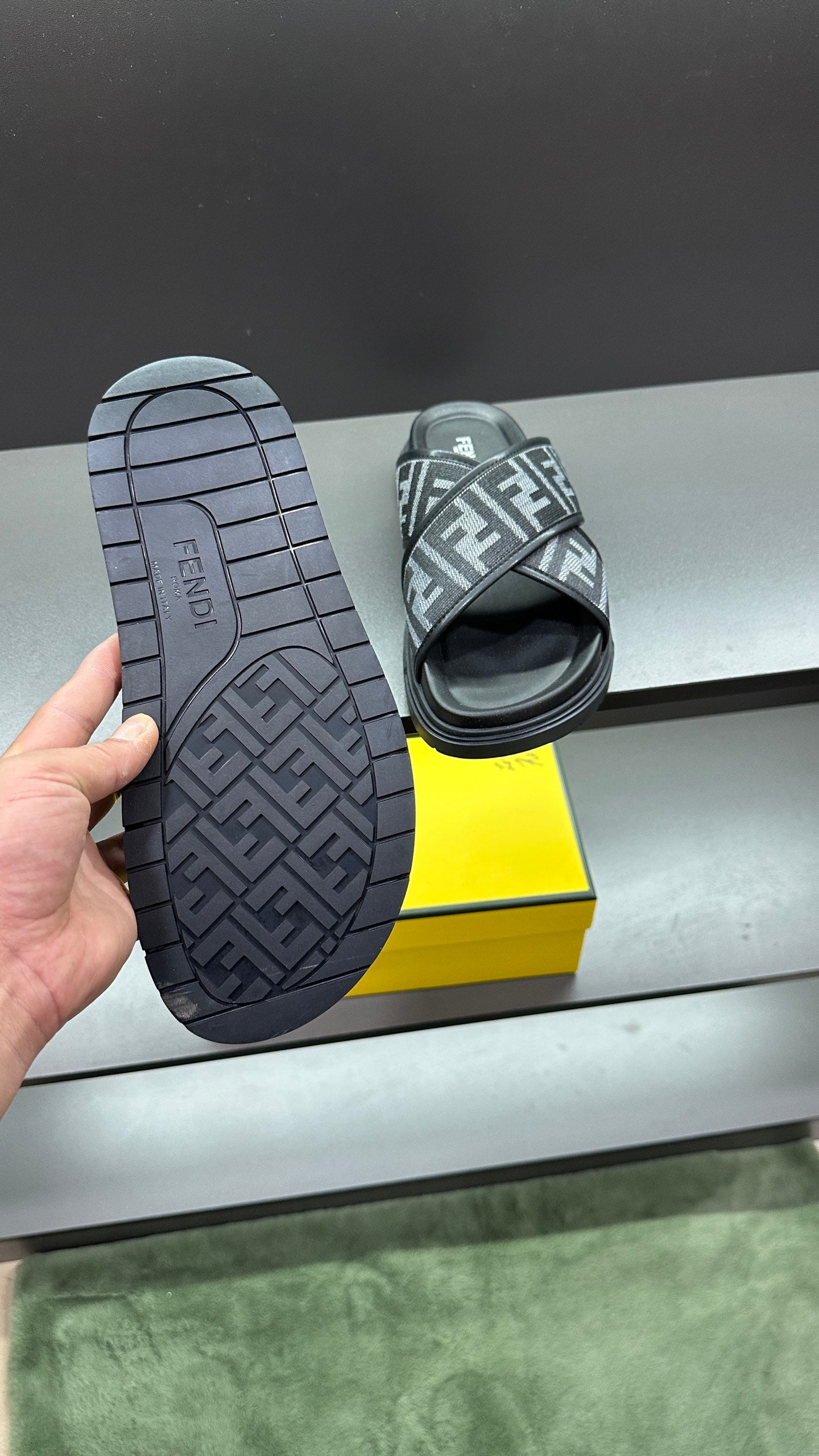 Fendi FF logo slide sandals outsole view, dark grid tread rubber and molded logo