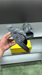 Fendi FF logo slide sandals held in hand, dark gray straps and textured outsole