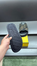 Fendi slide sandals showing treaded outsole with FF logo print on sole