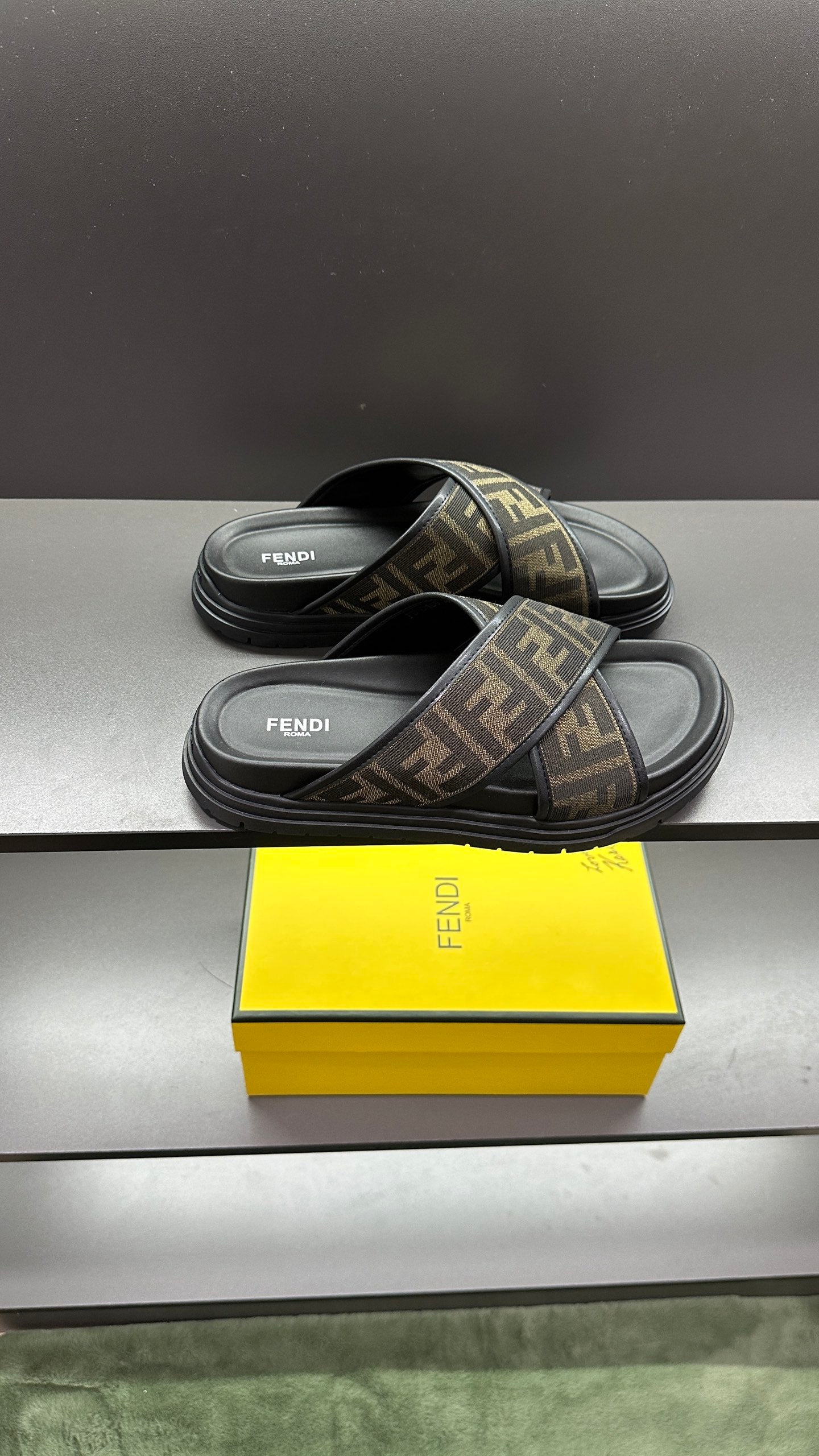 Fendi slide sandals, side view, FF logo monogram straps on dark sole