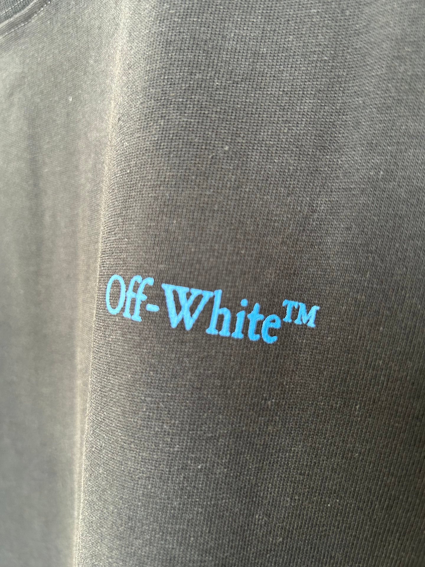 Off-White logo print on dark T-shirt fabric