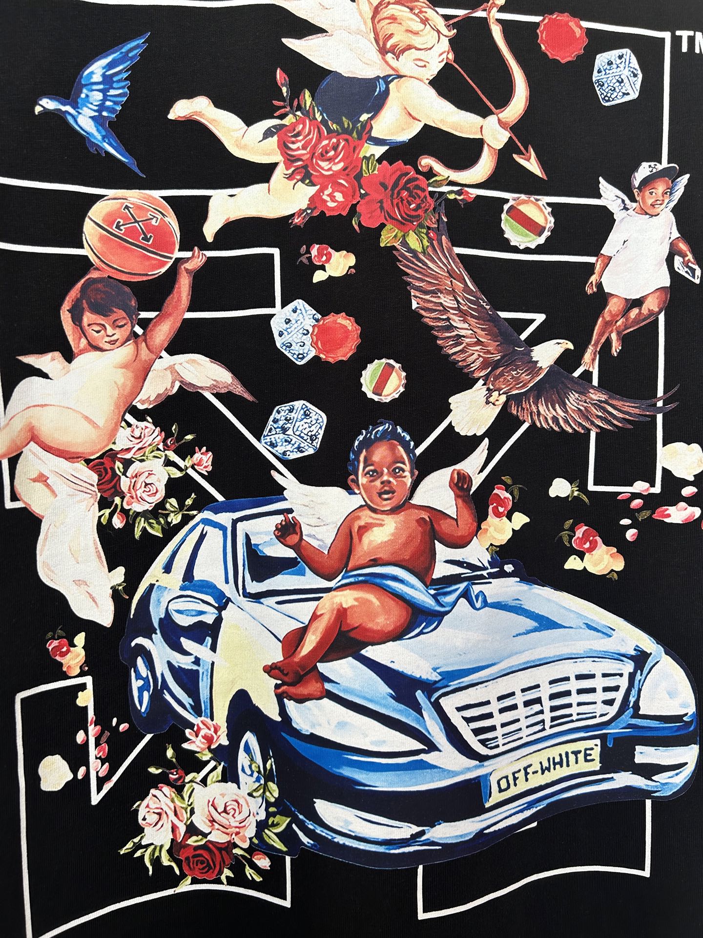 Off-White dark T-shirt graphic: winged figures, roses, and blue car