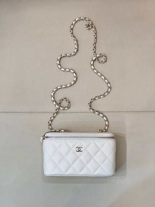 Chanel white quilted bag with diamond pattern, chain strap, zip top, CC logo.
