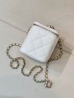 Chanel white quilted mini bag with chain strap, zip top, gold-toned hardware.