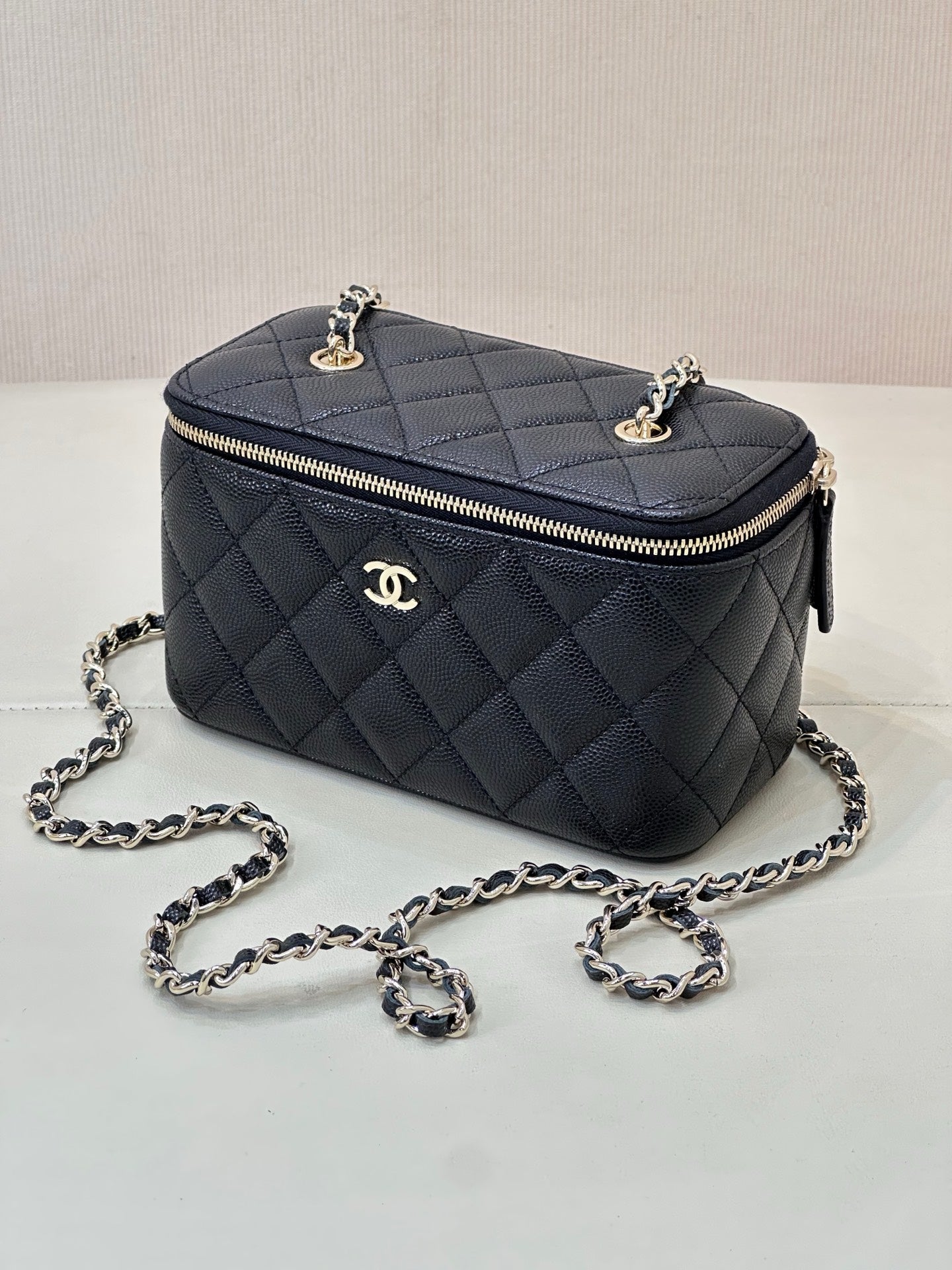 Chanel quilted mini bag, dark navy, top view with gold-tone hardware and chain