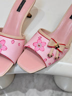 Pink Louis Vuitton ladies mules close-up: floral strap with gold-tone buckle accent