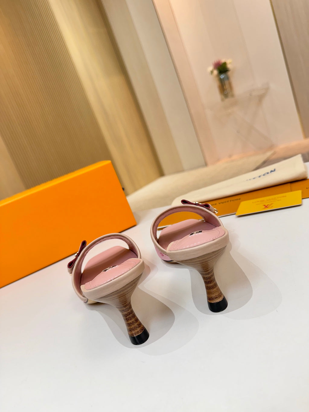Pink Louis Vuitton ladies mules viewed from back: heel and open strap detail