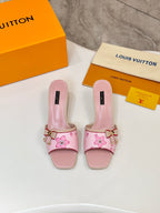 Pair of pink Louis Vuitton ladies mules with flower print, buckle strap, block heel